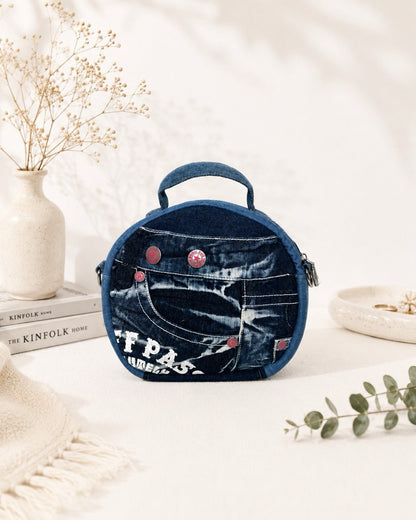 One-of-a-kind denim bag features red buttons, can wear as handbag or crossbody bag