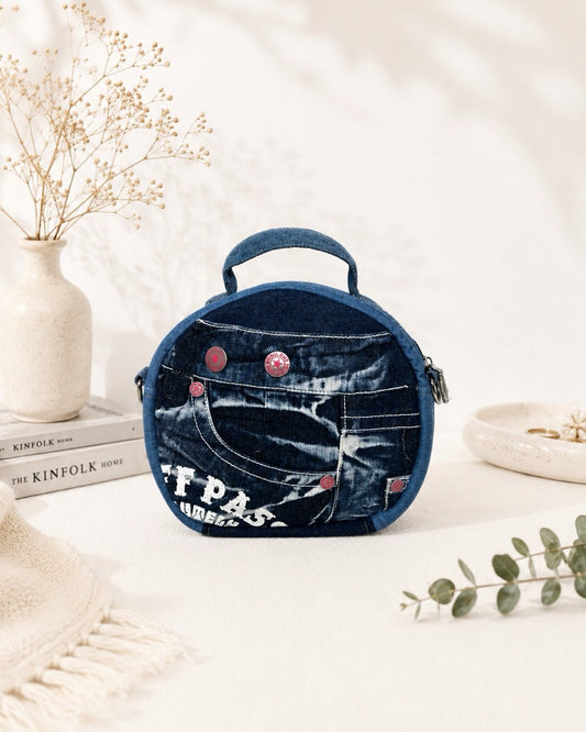 One-of-a-kind denim bag features red buttons, can wear as handbag or crossbody bag