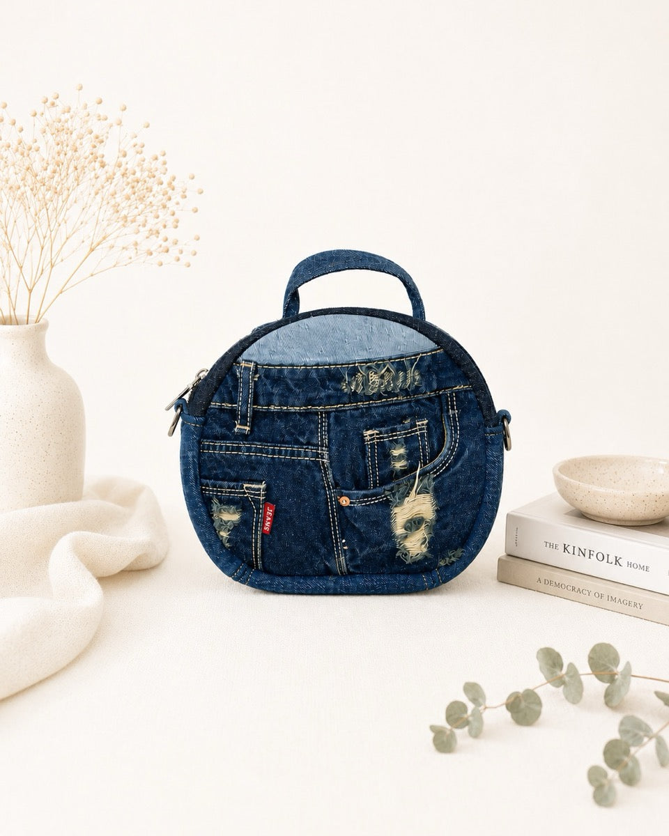 Handmade denim bag in round shape. Features with a long adjustable strap allows to wear as a handbag or a crossbody bag